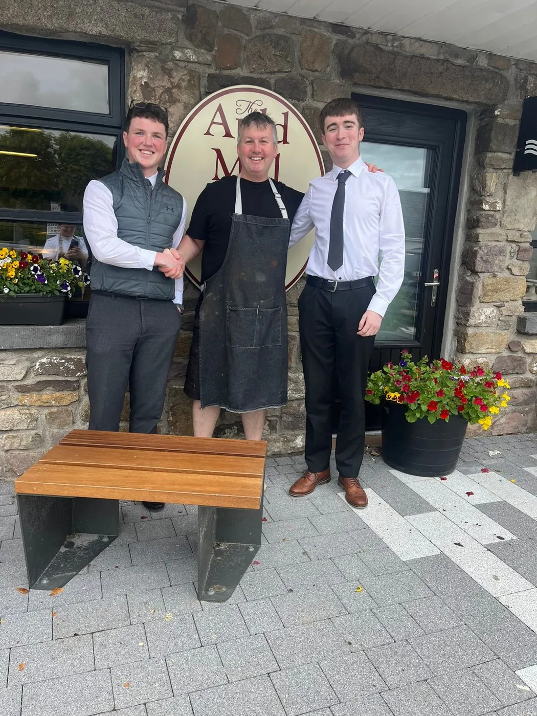 Dylan and Jake with the baker outside The Auld Mill